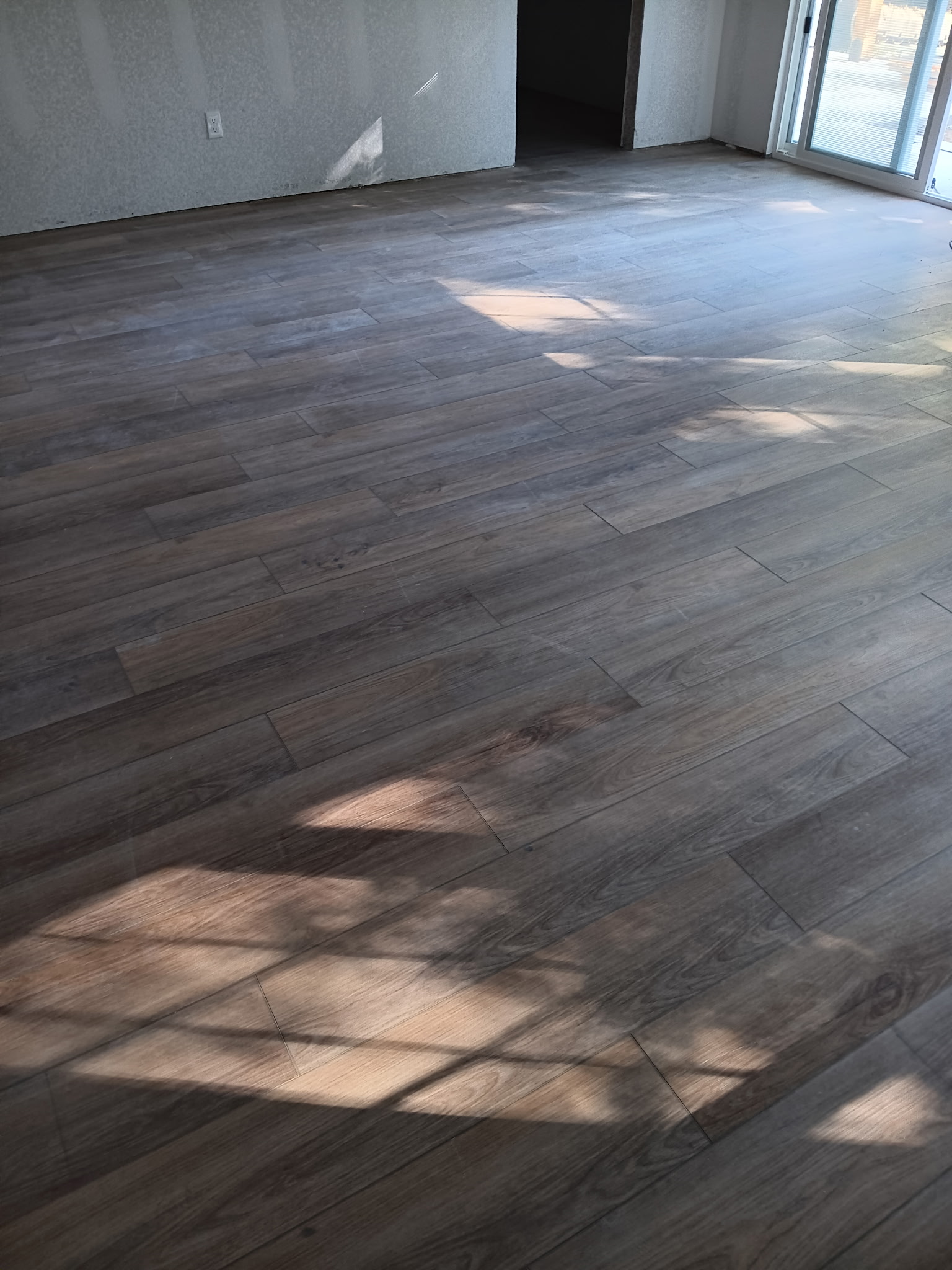 Wood-look flooring installed through an open residential room
